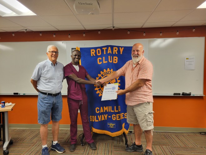 John Rohner and Brian Kesel welcomed new Rotary member Moses Munyuza at the August 12 meeting